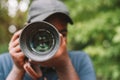 Close up portrait of african photographer taking pictures with digital camera Royalty Free Stock Photo