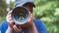 Close up portrait of african photographer taking pictures with digital camera.16:9 Style Royalty Free Stock Photo