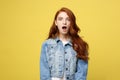 Close up Portrait amaze young beautiful attractive redhair girl shocking with something. Isolated on Bright Yellow Royalty Free Stock Photo