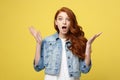 Close up Portrait amaze young beautiful attractive redhair girl shocking with something. Isolated on Bright Yellow Royalty Free Stock Photo