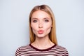 Close up portrait of amazing woman pulled her lips to kiss someone, blowing kiss to camera, sending kiss with full lips, gives