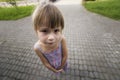 Close-up portrait, angled view from above of little blond pale unhappy moody friendless child girl