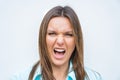 Close up portrait of angry mad woman face. Female screaming or shouting. Concerned and stressed woman