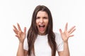 Close-up portrait of angry, pissed-off aggressive woman screaming at person, shouting and shaking hands from anger and Royalty Free Stock Photo