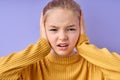 Close up portrait of angry stressed out teenage girl plugging ears with hands Royalty Free Stock Photo