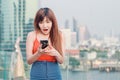 Close up portrait anxious young girl looking at phone seeing bad news or photos with disgusting emotion on her face over outside