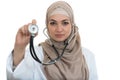 Close up portrait of arab female doctor smiling while using stethoscope Royalty Free Stock Photo