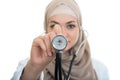 Close up portrait of arab female doctor smiling while using stethoscope Royalty Free Stock Photo