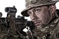 Close-up portrait of army soldier aiming rifle