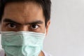 Close-up Portrait of an Asian handsome man adult wearing a protective medical mask Royalty Free Stock Photo