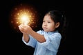 Close-up portrait Asian kid girl highly confident, a committed face with two hands holding a lamp orange light.