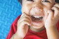 Close-up portrait Asian kids, Caucasian boy little child sleeping wearing a Red t-shirt smiling and making a funny face at the Royalty Free Stock Photo