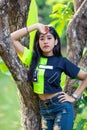 Asian young woman posing near the tree