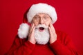 Close up portrait astonished old retired pensioner man in santa claus hat impressed newyear event news touch grey beard