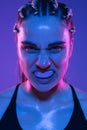 Close-up portrait of athletic girl MMA fighter isolated on blue background Royalty Free Stock Photo