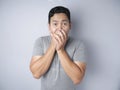 Asian Man Shocked and Closing his Mouth Royalty Free Stock Photo