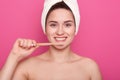 Close up portrait of attractive caucasian smiling woman isolated over pink studio, brushing her teeth in bathroom, doing morning Royalty Free Stock Photo