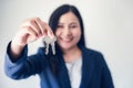 Business Woman in Uniform Suit Showing Keys for Rent Estate Housing , Beautiful of Businesswoman Broker Giving a Key to Customer, Royalty Free Stock Photo