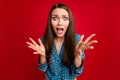 Close-up portrait of attractive desperate puzzled girl bad news panic isolated bright red color background