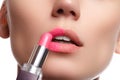 Close up portrait of attractive lips of beautiful woman. Rouging her lips with pink mate lipstick. The lady is gently smiling. Clo Royalty Free Stock Photo