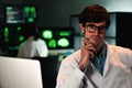 Close up portrait of attractive medical doctor with glasses and lab coat looking at camera. Front view of handsome Royalty Free Stock Photo