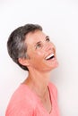 Close up portrait of attractive middle age woman laughing and looking up Royalty Free Stock Photo