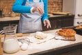 Close-up portrait of attractive smiling happy senior aged woman is cooking on kitchen. Grandmother making tasty baking Royalty Free Stock Photo
