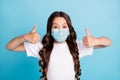 Close-up portrait attractive wavy-haired girl showing double thumbup approve white medical mask quality safe covid