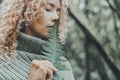 Close up portrait of attractive woman and big tropical leaf near her face. Feeling with nature and people concept lifestyle. Green Royalty Free Stock Photo