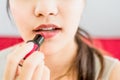 Close up portrait of attractive woman holding light pink lipstick apply to lips,Concept beauty and charm of women and makeup