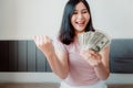 Close-Up Portrait of Attractive Woman Holding Money Cash From Savings With Happy Expression on Her Bedroom. Business Financial and Royalty Free Stock Photo