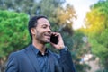 Close up portrait of attractive young african american man talking on mobile phone outdoors Royalty Free Stock Photo