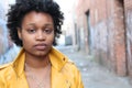 Close up portrait of an attractive young black woman with afro hair with copy space on the right Royalty Free Stock Photo