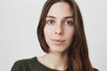 Close up portrait of attractive young female brunette with cute smile on her face expressing interest in something Royalty Free Stock Photo