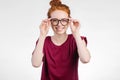 Portrait of attractive young redhead woman smiling with glasses