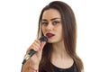 A close-up portrait of attractive young singer with a microphone Royalty Free Stock Photo