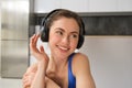 Close up portrait of attractive young smiling woman, workout, doing fitness training, listening music in headphones Royalty Free Stock Photo