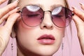 Close-up portrait of attractive young woman in tinted glasses  and closed eyes Royalty Free Stock Photo