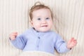 Close up portrait of baby in blue knitted sweater Royalty Free Stock Photo