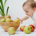 Close up portrait baby boy take apple Royalty Free Stock Photo