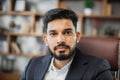 Close up portrait of bearded handsome successful middle east smiling businessman sitting at chair Royalty Free Stock Photo