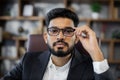 Close up portrait of bearded handsome successful middle east smiling businessman sitting at chair Royalty Free Stock Photo