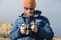 Close-up portrait bearded male photographer in sunglasses with dslr camera in his hands looks at the photos on the Royalty Free Stock Photo