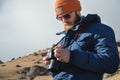 Close-up portrait bearded male photographer in sunglasses with dslr camera in his hands looks at the photos on the Royalty Free Stock Photo