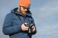 Close-up portrait bearded male photographer in sunglasses with dslr camera in his hands looks at the photos on the Royalty Free Stock Photo