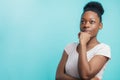 Beautiful African American woman looking up with distrustful look