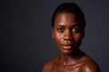 Close up beautiful african woman looking at camera with naked shoulders