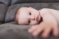 Close up portrait of beautiful baby boy lying on the sofa and looking at the camera. Family concept Royalty Free Stock Photo