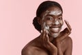 Black girl wash face with cleansing face foam Royalty Free Stock Photo