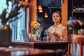 Close-up portrait of a beautiful black-skinned woman wearing a blouse and flower headband, holds cup of coffee in a Royalty Free Stock Photo